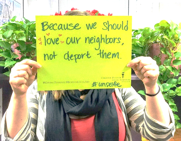 Person holding a sign supporting immigrants