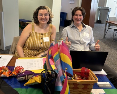 Staff members sit at a registration table at the name change clinic