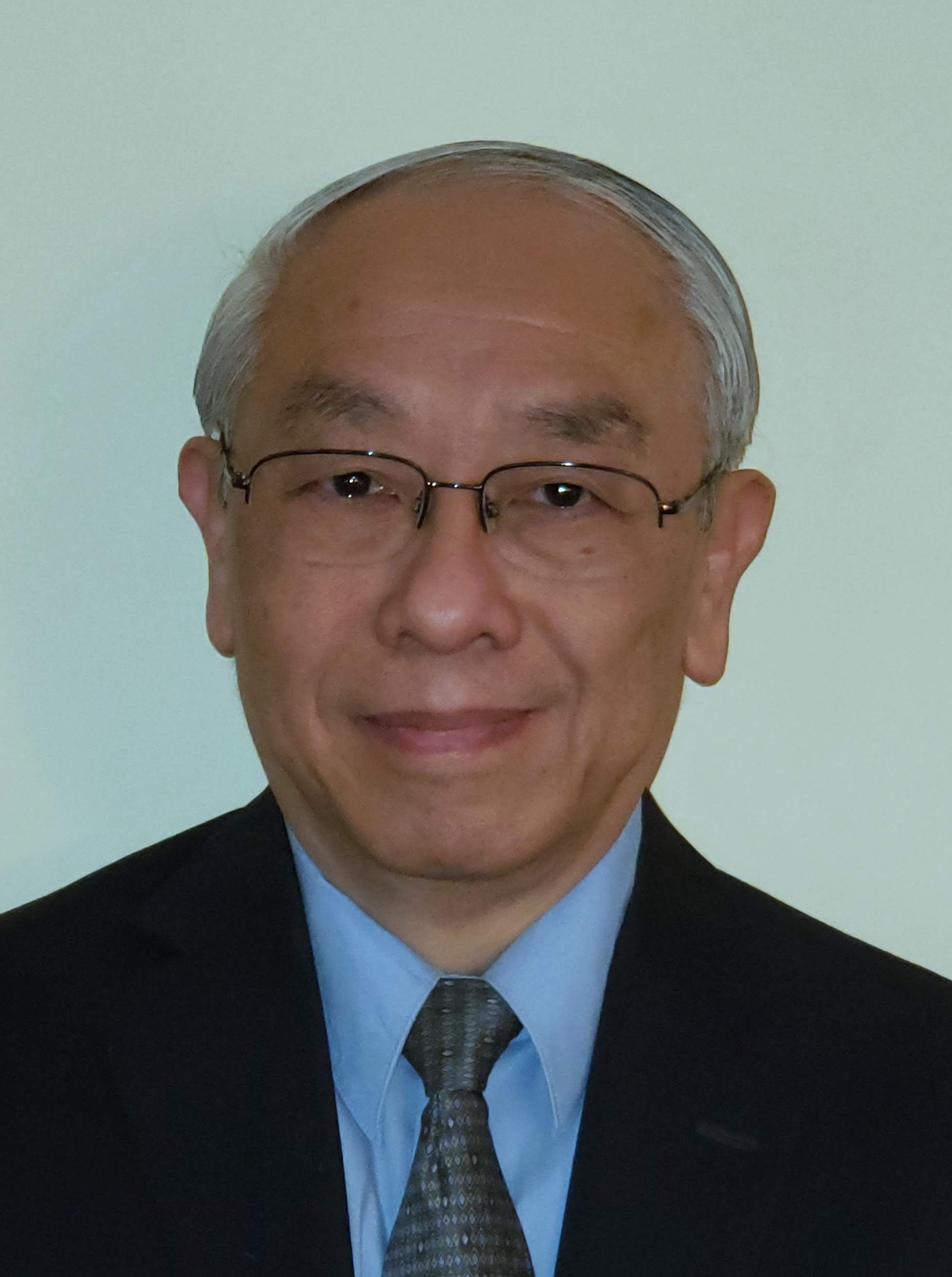 Headshot of Quang Nguyen, GBLS Human Resources Director. Quang is wearing a suit and glasses.