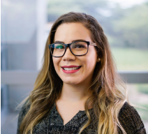 Woman with long brown hair and wearing glasses