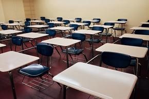 Photo of students' desks lined up in a classroom. 