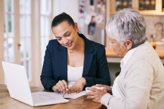 Legal advocate reviewing documents with an older client