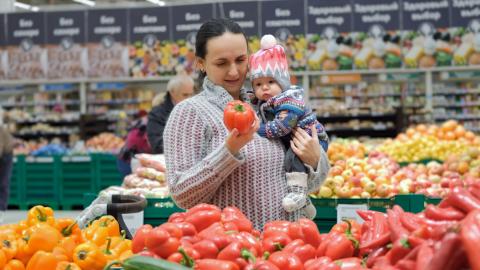 woman holding a baby in a grocery store