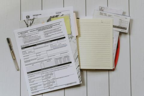tax documents laying on a white wood floor
