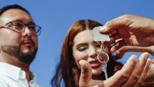 A couple receives the keys to a new home
